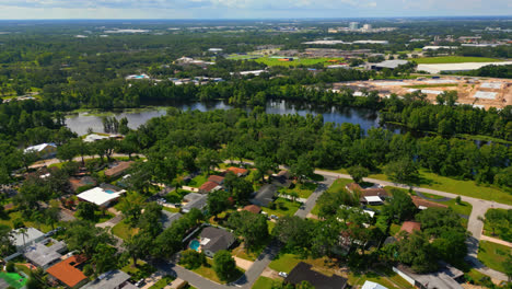 drone flying towards the hillsborough river over a residential neighborhood with abundant greenery in tampa, florida