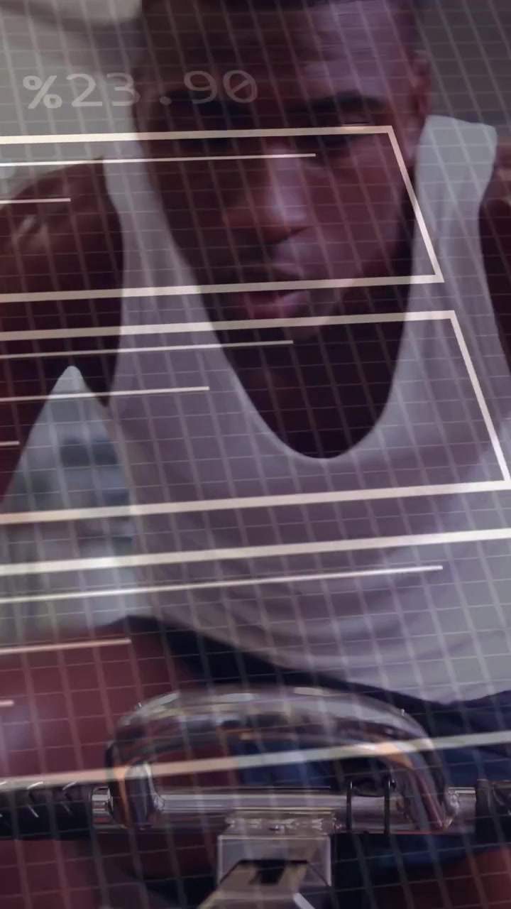 Vertical video: Adult man leaning on bike bars, initiating HUD overlay and analysing fitness data