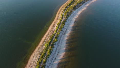 4k aerial footage: unveiling the enchanting super thin beach isthmus in hiiumaa island, estonia