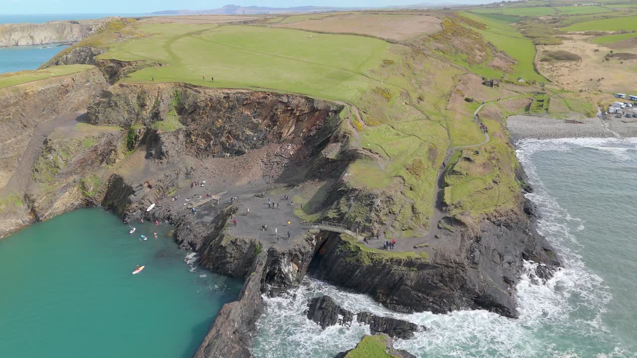 Aerial View of Stunning Coastline with Turquoise Water and Cliff Jumpers