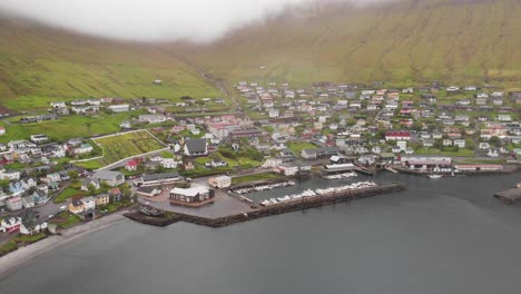 aerial over village and fjord at the faroe islands