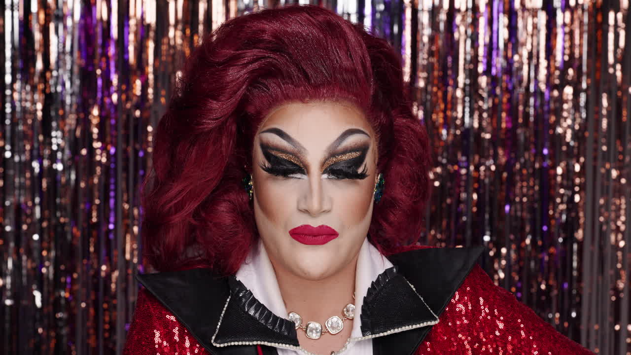Drag queen portrait with red hair and bold makeup