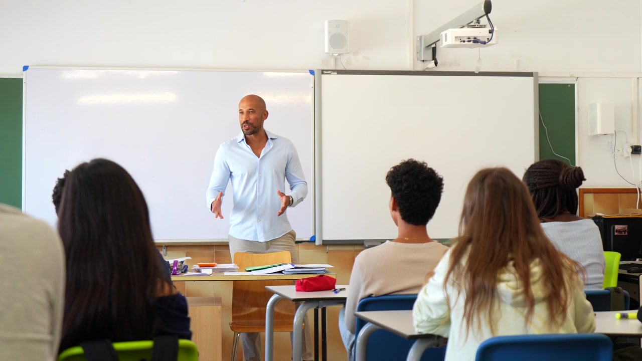 Male Teacher Giving a Lesson to Students in a Classroom