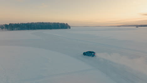 drifting car speeding on corner on norbotten woodland ice lake aerial tracking view at sunrise