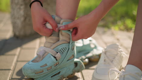 close-up of individual adjusting strap on roller skate of right leg with black wristband, with slight forward movement, second roller skate slightly blurred in background