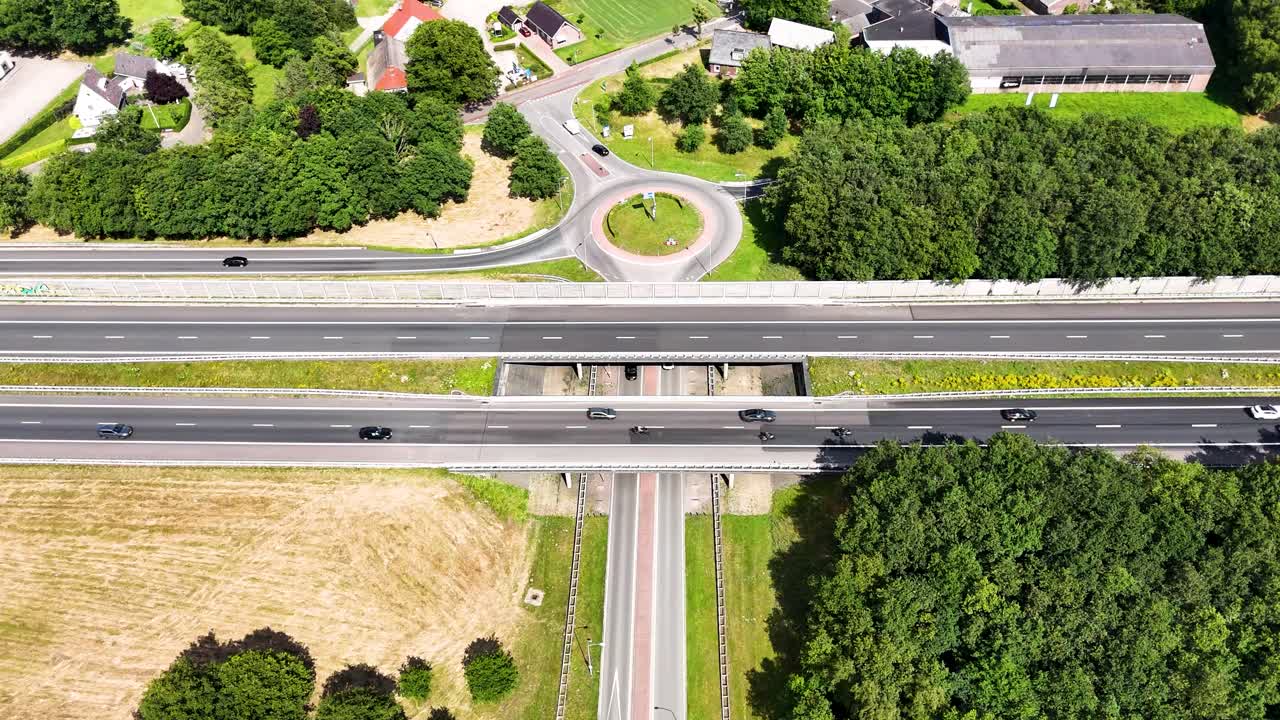 Aerial view of a highway intersection with roundabout and overpass