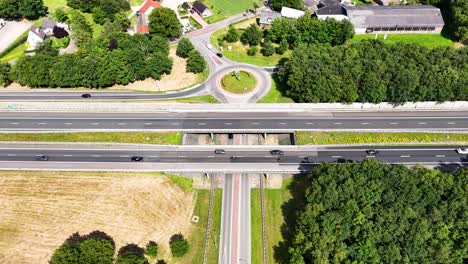 aerial view of a highway intersection with roundabout and overpass