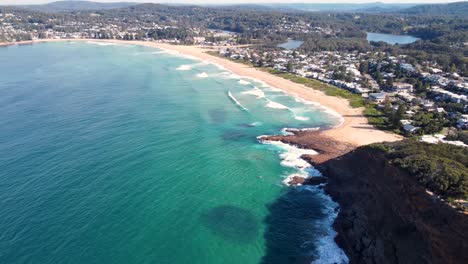 drone aerial pan footage of north avoca beach with ocean waves headland coastline central coast nsw australia 4k