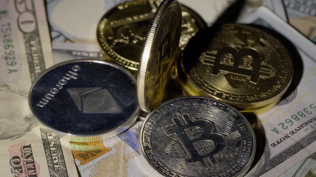 Bitcoin BTC coin and Ethereum ETH coins rotating on bills cash of 100 dollars, virtual money mining