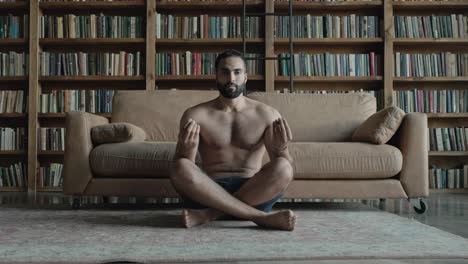 young man meditates in the library.