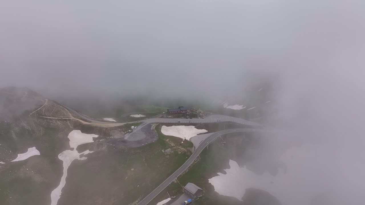 Heavy fog covers Großglockner High Alpine Road, creating a mysterious atmosphere