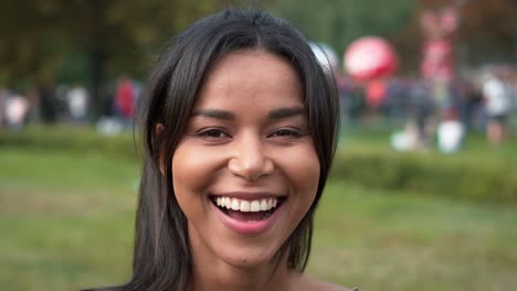 close up of multiracial woman looking at camera at music festival