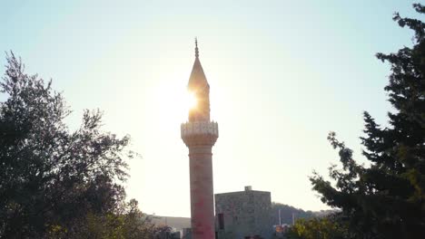 sun behind the pillar of fortress 'bodrum kalesi' in bodrum, turkey