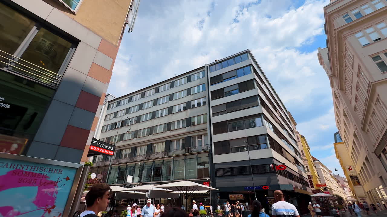 Vienna, Austria - June 9, 2025: Busy streets of modern Vienna, Austria. Low angle view at the buildings along the street