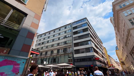 vienna, austria - june 9, 2025: busy streets of modern vienna, austria. low angle view at the buildings along the street
