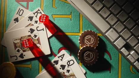 cards, dice, and chips on a green felt table with a keyboard