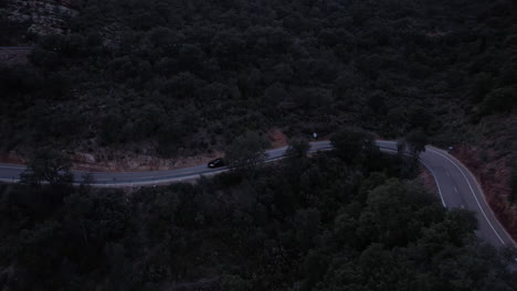 car-driving-remote-mountain-ridge-during-dawn,-cinematic-aerial-automotive-shot-honda-civic-type-r-remote-mountain-pass-during-dusk