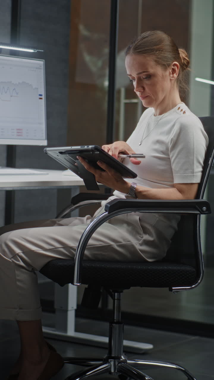 Female Financial Analyst Working on Computer with Multi-Monitor Workstation, Monitoring Real-Time Stocks and Exchange Market Charts. Successful Businesswoman in Financial Agency Office. Vertical Shot.