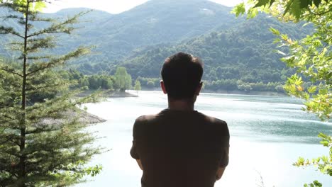 man looking natural lake