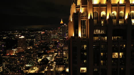 Drone-Shot-at-Night-in-Atlanta,-Georgia,-Reveal-of-Distant-Building,-Midtown