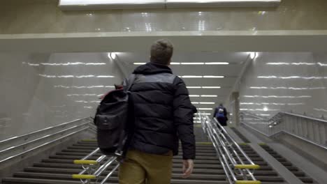 man walking up subway stairs