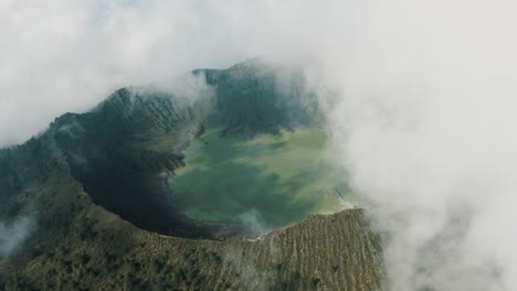 Aerial-birds-eye-shot-of-vast-El-Chichón-Volcano-with-hovering-clouds-and-acidic-crater-lake-in-sunlight,Mexico