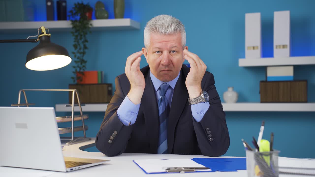 Well-groomed and smiling positive businessman looking at camera.