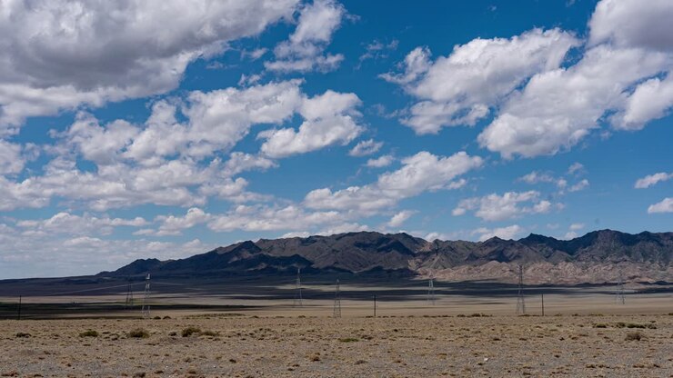 The time-lapse of the cloudy sky over the field in spring