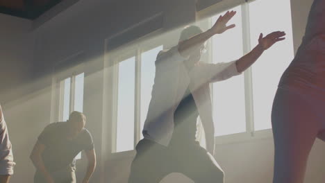 senior men practicing tai chi in sunlight indoor