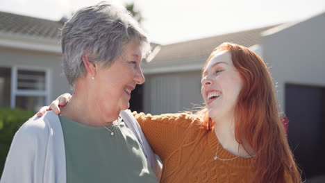 Senior-mom,-daughter-and-hug-on-street