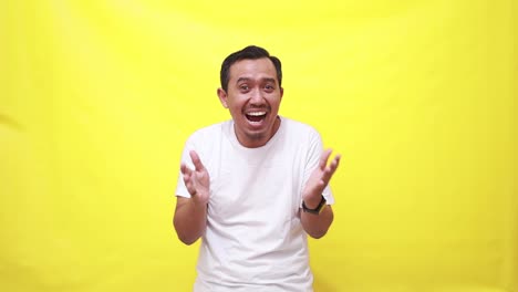 wow excited asian adult man standing with surprised face expression while looking at the camera