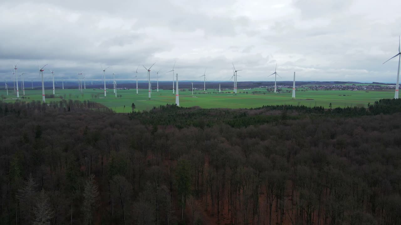 Sustainable Energy Production in North Rhine-Westphalia: Row of Wind Turbines at Wind Farm near Bad Wünnenberg, Paderborn Surrounded by Trees