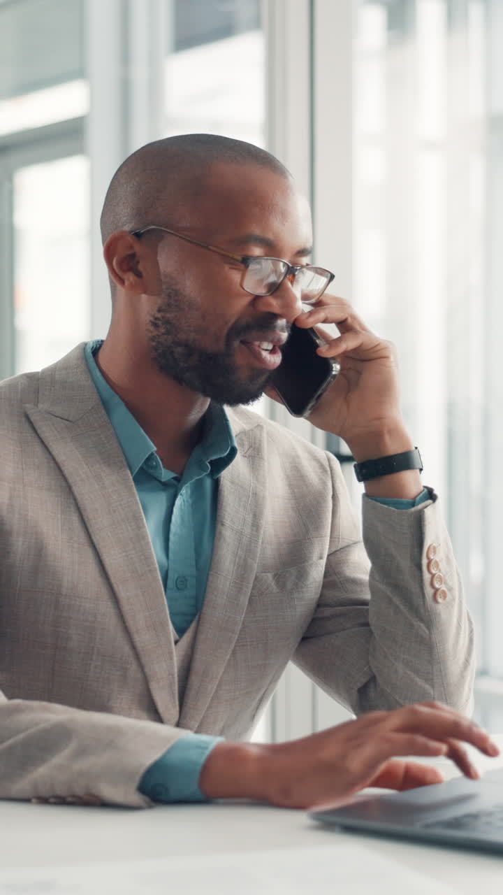 Smiling Man on Phone Call While Working on Laptop