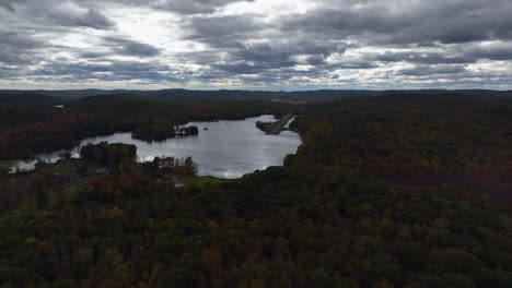 Aerial-view-of-the-countryside-in-Stormville,-New-York-on-a-cloudy-day-in-autumn-with-Black-Pond-in-view