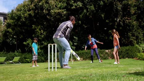 happy family playing cricket