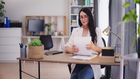 Businesswoman-Organizes-Documents-and-Stretches-in-Office