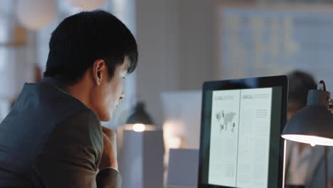 asian businessman working late in offce using computer having phone call discussing project deadline planning solution