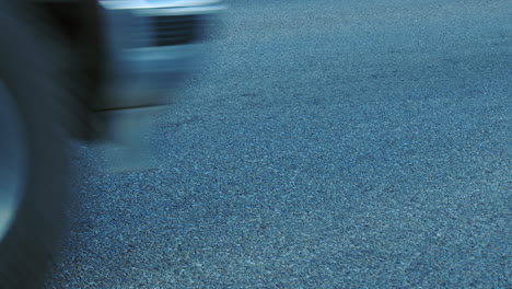 urban infrastructure: low angle asphalt street with cars driving past