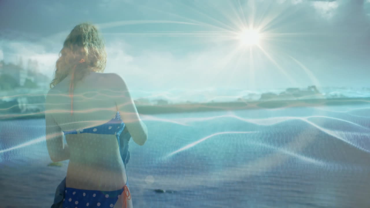 On sunny beach, woman in polka dot swimsuit relaxing, bright sun overhead