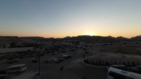 Timelapse-of-a-beautiful-sunset-in-Petra-valley-in-Wadi-Musa,-Jordan-in-the-middle-of-a-rocky-and-mountainous-landscape,-an-UNESCO-heritage-site,-ancient-Nabatean-Kingdom-4K-Establish-Shot