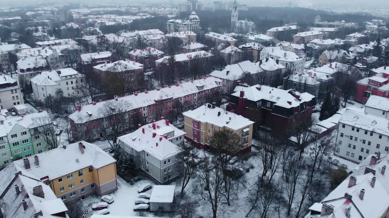 Winter aerial view of a city with snow-covered buildings