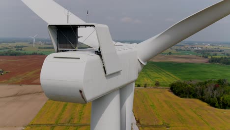 wind turbine rear aerial panning shot of the nacelle with propeller blades