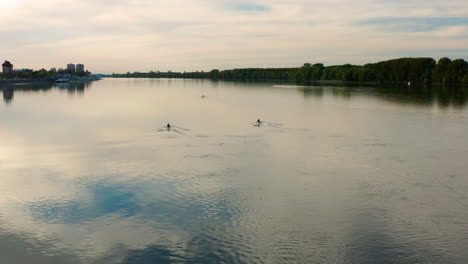 peaceful danube river with people rowing at sunset near vukovar city, croatia