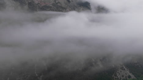 clouds rolling over a mountain