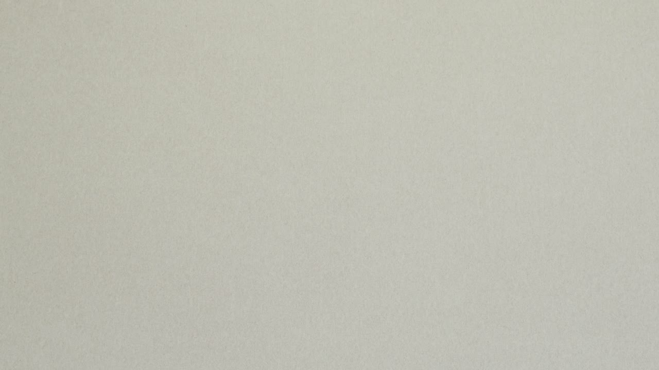 Red crumpled paper unfolds on grey in a stop motion transition