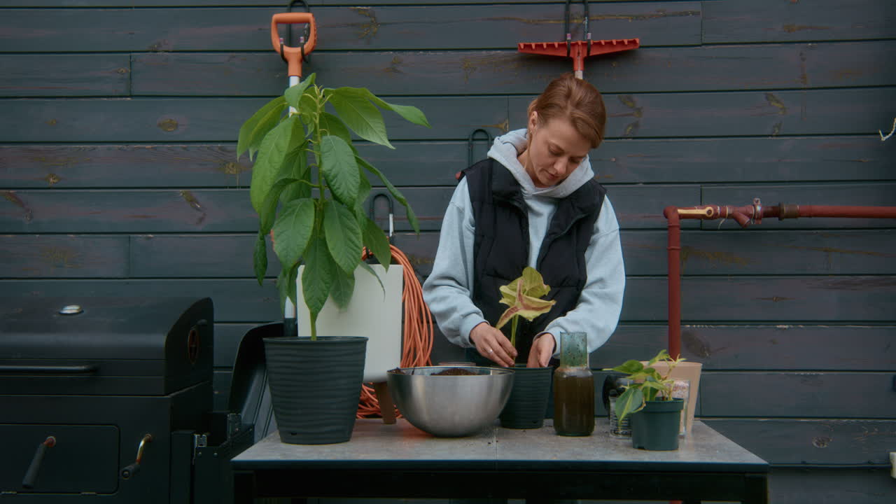 Woman Replanting Plants on Patio
