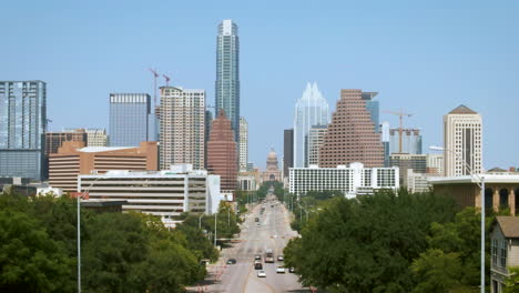 Aerial-of-tree-lined-South-Congress-Avenue-leading-to-Texas-Capitol-building-in-Austin,-drone-4K