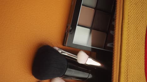 makeup brushes and palette in a makeup bag
