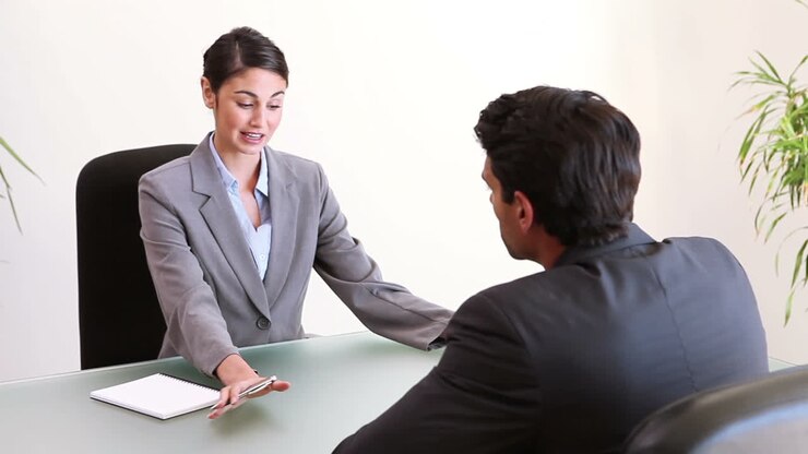 Business people talking while sitting at a desk