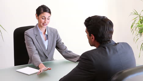 Business-people-talking-while-sitting-at-a-desk